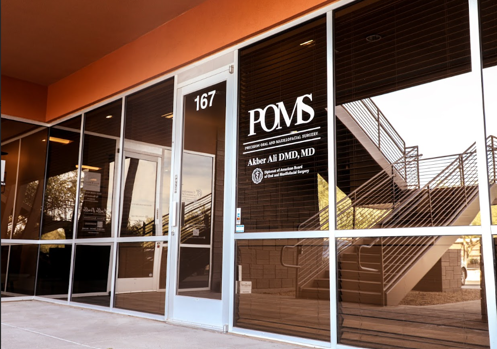 Exterior of POMS clinic at 167 — glass entrance and staircase