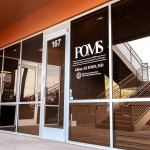 Exterior of POMS clinic at 167 — glass entrance and staircase