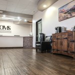 Modern POMS clinic waiting area with wood floors and front desk