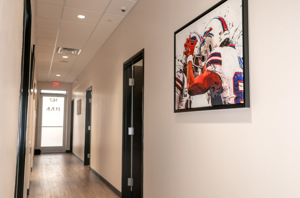 Clinic hallway with football artwork on wall