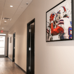 Clinic hallway with football artwork on wall
